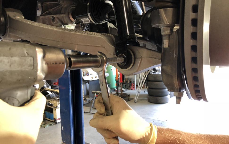 Carefully remove the lower control arm mounting/adjusting bolts so that the lower control arm can be dropped out of its frame