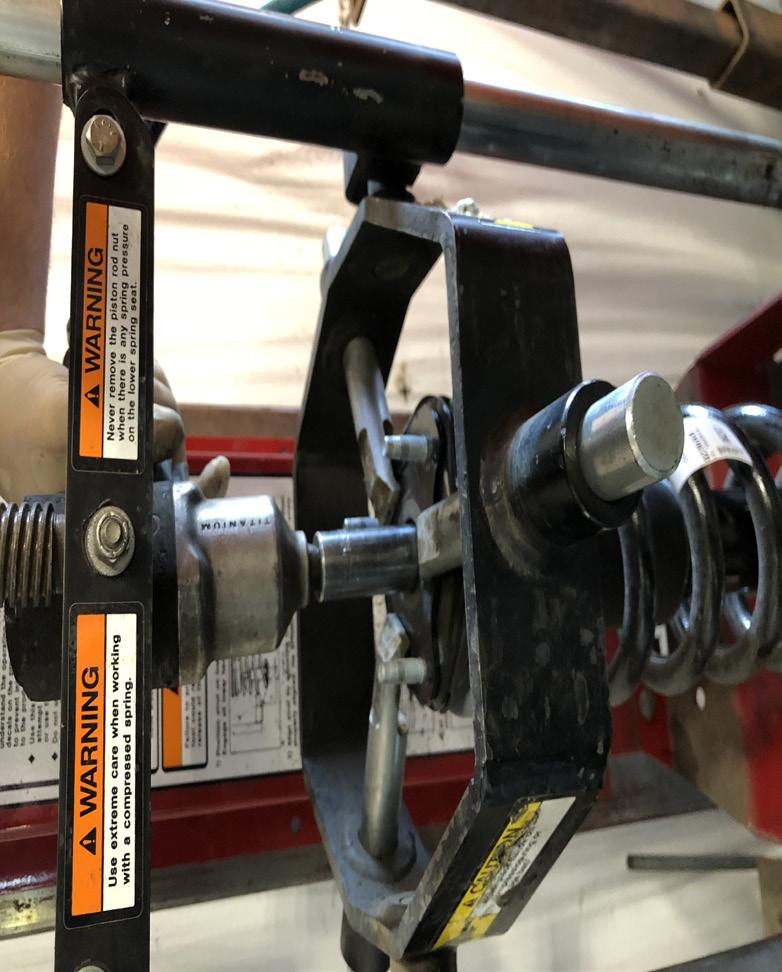 Install the new aluminum strut spacer on top of the coil spring.