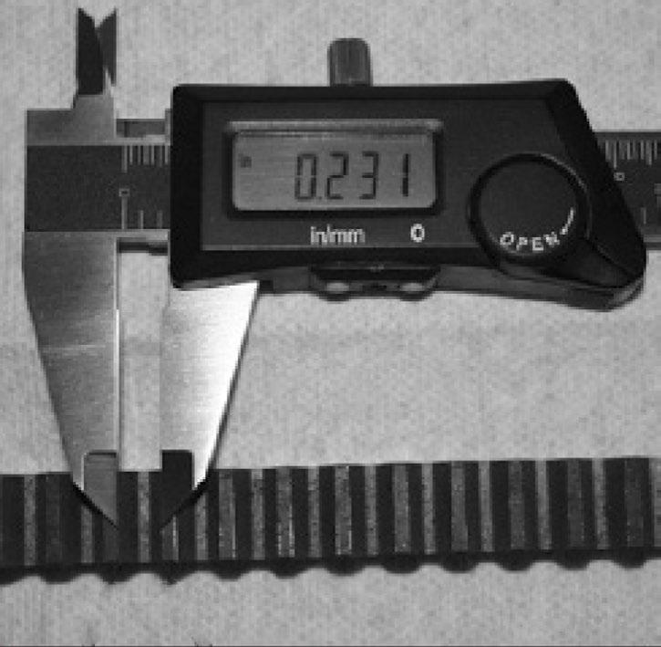 Using calipers or a steel rule, measure from the inside edge of one tooth (), and then