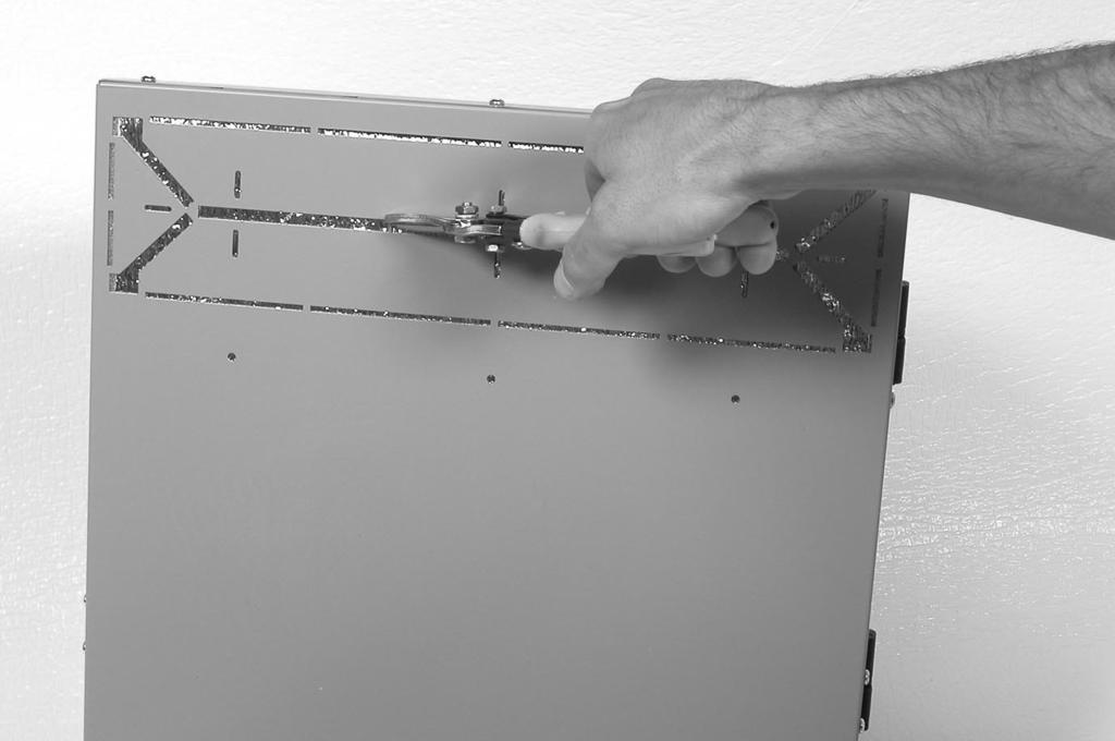 Once the holes are made in the main return duct and the unit is aligned, the