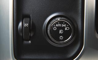 With the vehicle in Park, push down the lever (B) closer to the instrument panel on the left side of the steering column to move the steering wheel in or out.