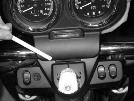 ROAD GLIDE FLTR You will need to remove the speedometer and tachometer instrument bezel. To do this, remove two small screws on the left and right side of the bezel.