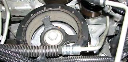 Torque the flywheel holding tool bolts to 37 ft/lbs. 15. Use a breaker bar and a 24mm socket to loosen and remove the crank bolt.