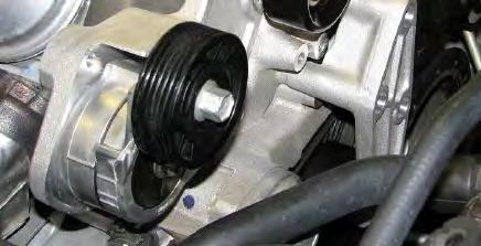 Note that you must slide the belt around the bottom of the bracket to get the belt on the lower passenger side idler pulley. 57.