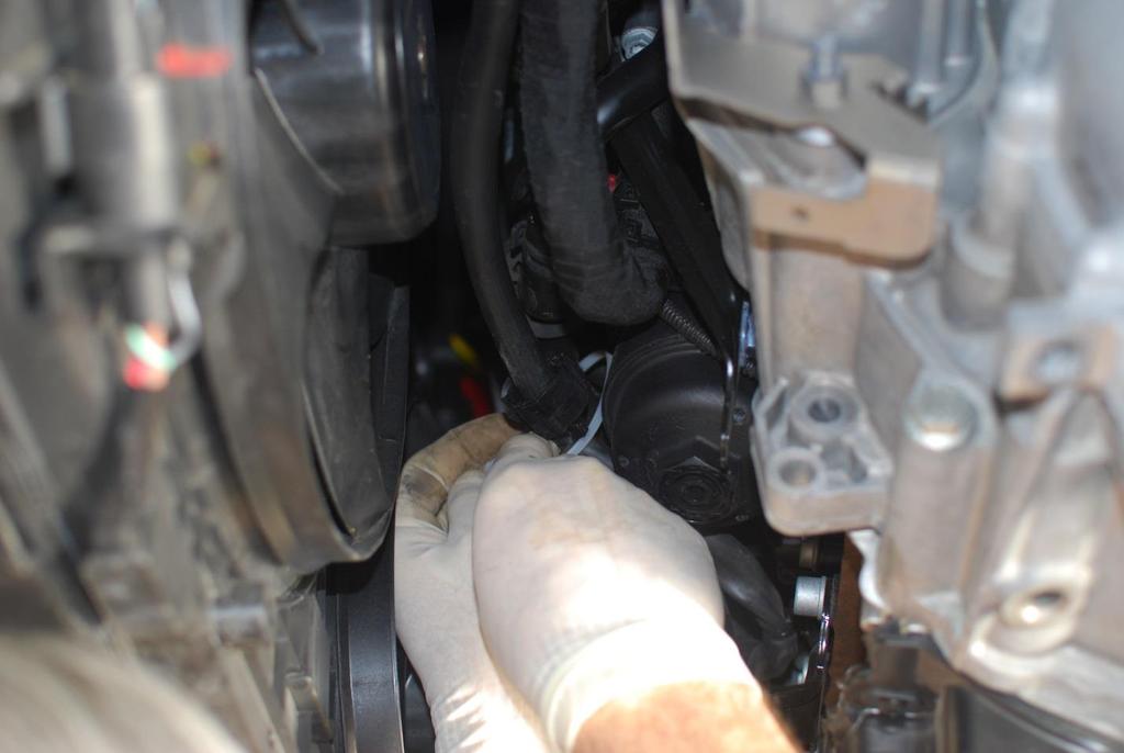 A cable tie placed around a coolant hose keeps the
