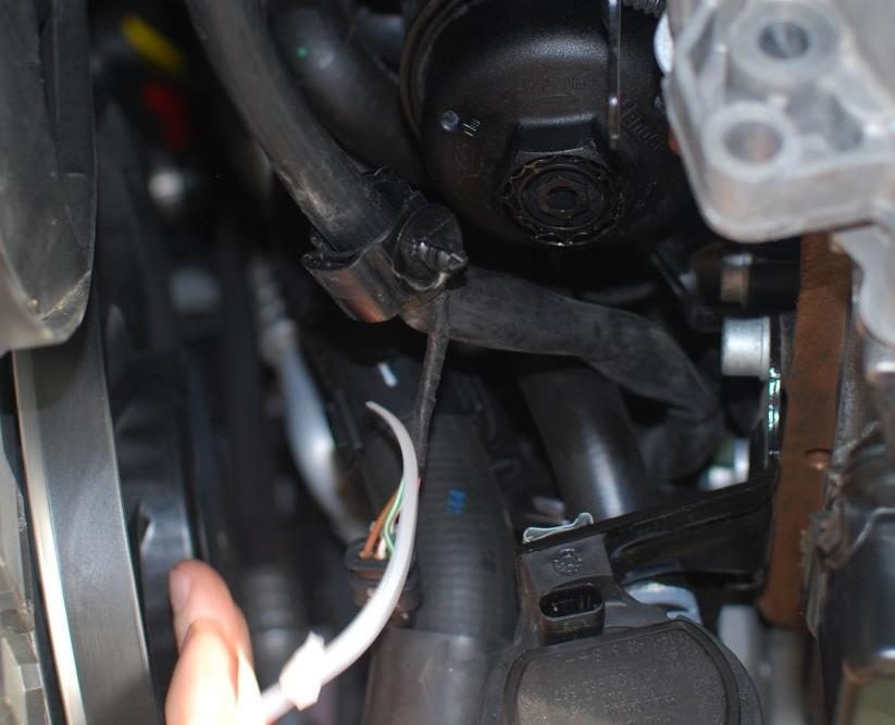 Cut the cable tie with some side cutters and remove. Wiring harness plugged back in.
