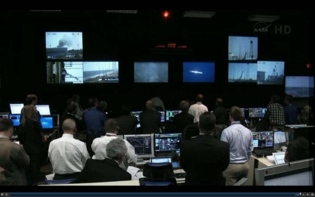 NASA Wallops Island Rocket Control Center. Points of interest: All eyes are looking forward and the excitement is focused on the Large Video Screens during the test launch.