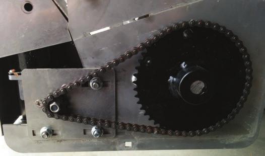 Maintenance Adjusting Chain Tension 4. Remove bolt (E) and lift bottom of shield until it is rotated about 90 and pull out. E Removing and Storing Removing Spreader From Tractor 1.