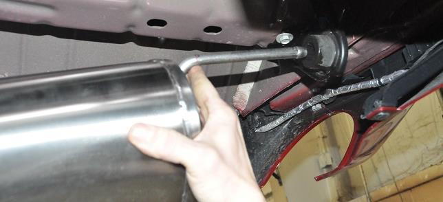 Install the clamp on the passenger side muffler inlet pipe so that the bolt is vertical with the nut towards the ground