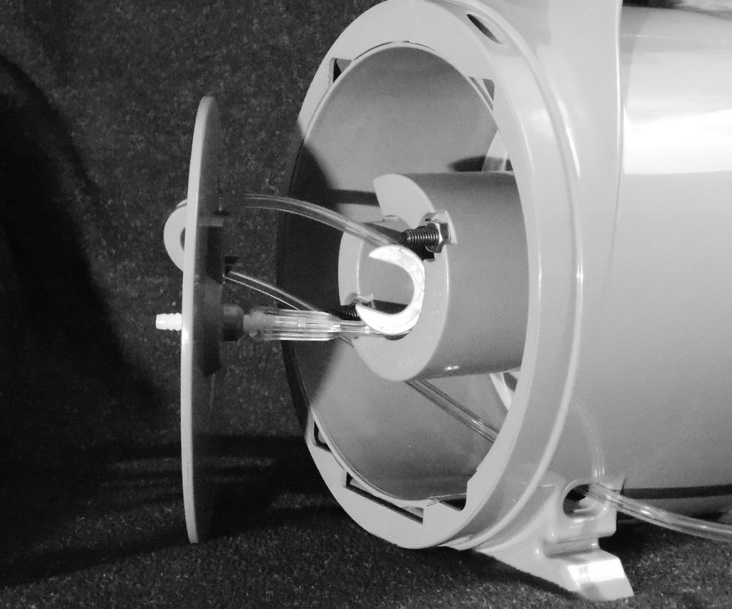 Replace spool end-cap, running tubing through the slot in the spool hub. Be careful not to pinch tubing between the spool end-cap and the spool hub.