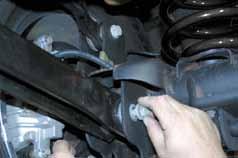 48. Disconnect the lower control arm (only disconnect one side at a time so that the axle is not free to move). (See Photo # 41) 49.