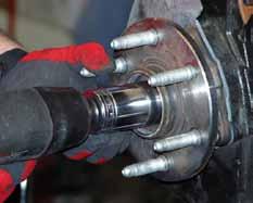 8. Remove the outer cv axle nut dust cover to allow access to the outer cv axle nut.
