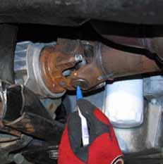 Disconnect the front driveshaft using a 7/16" wrench. Note: Be sure to mark the U-joint & yoke at the differential.