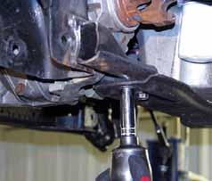 15. With the welds ground off, remove the cross member mounting bolts using a 18mm wrench & remove