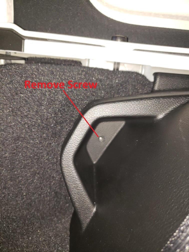 13. Remove single screw in rear trunk panel on side of
