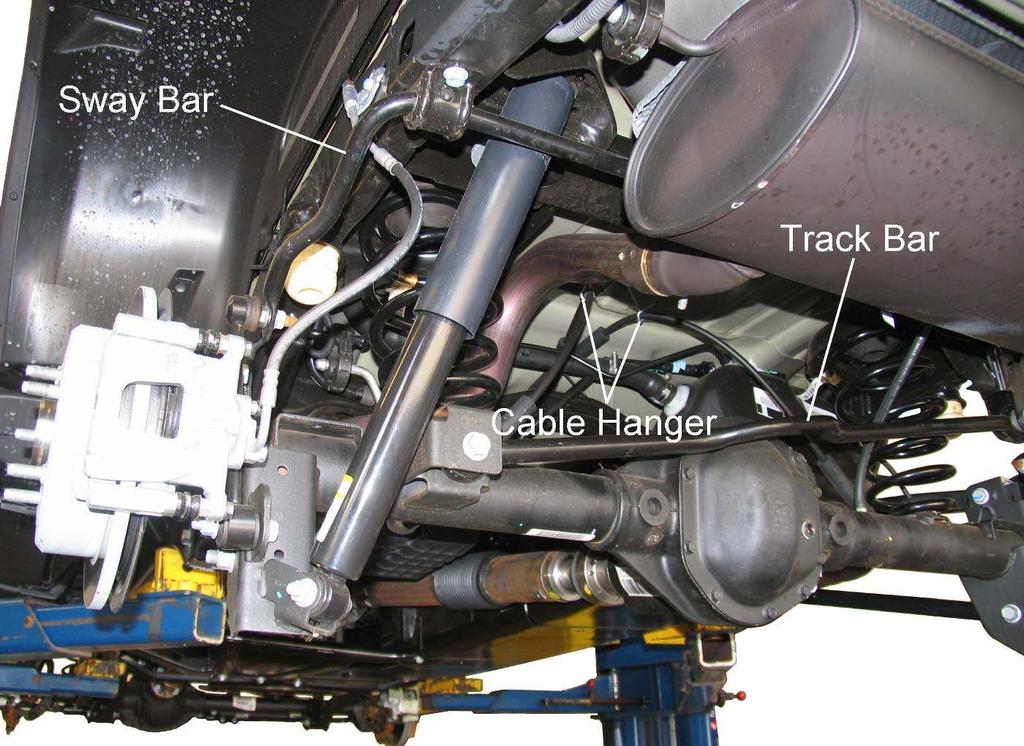Rear Suspension REAR SUSPENSION SHOCK ABSORBER & COIL SPRING REMOVAL 1) Chock front wheels. Disconnect the track bar from the frame bracket. Disconnect the sway bar end links from the axle brackets.