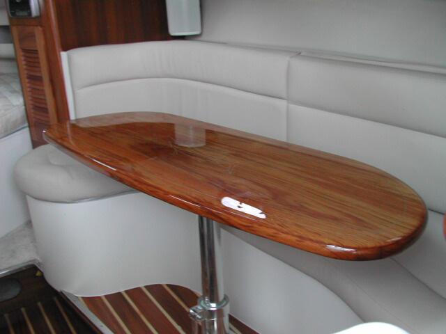 There also is recessed lighting below the teak trim at the base of the raised dinette floor that is activated by the switch on the starboard side of the companionway. L-Lounge and Table 10.