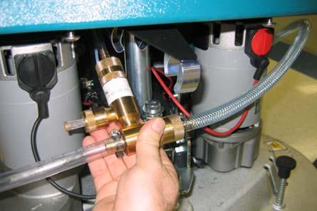 To access the detergent injector assembly, lower the scrub head and remove the front shroud