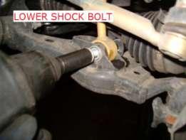8. Remove the lower shock nut and bolt. 9.