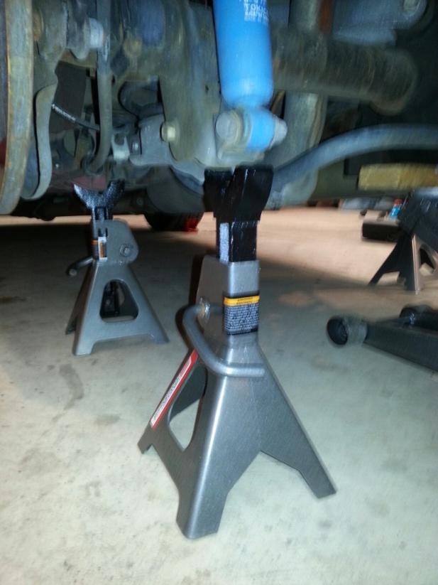 Place a jack stand under the axle on the opposite side that you will be working on.