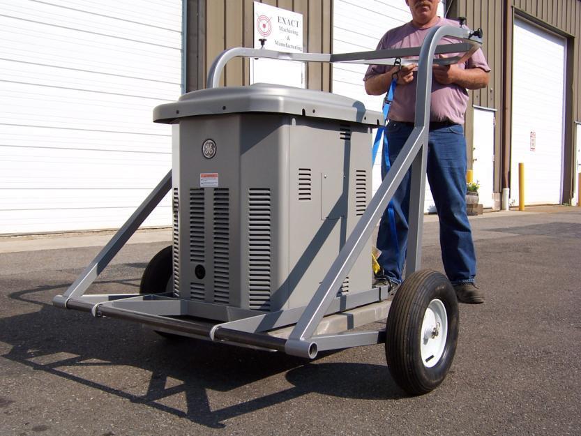 Using the same technique as described on the horizontal generators, pull down on the handle and pull down on the blue strap at the same time. This will lift the generator onto the UTP cart.