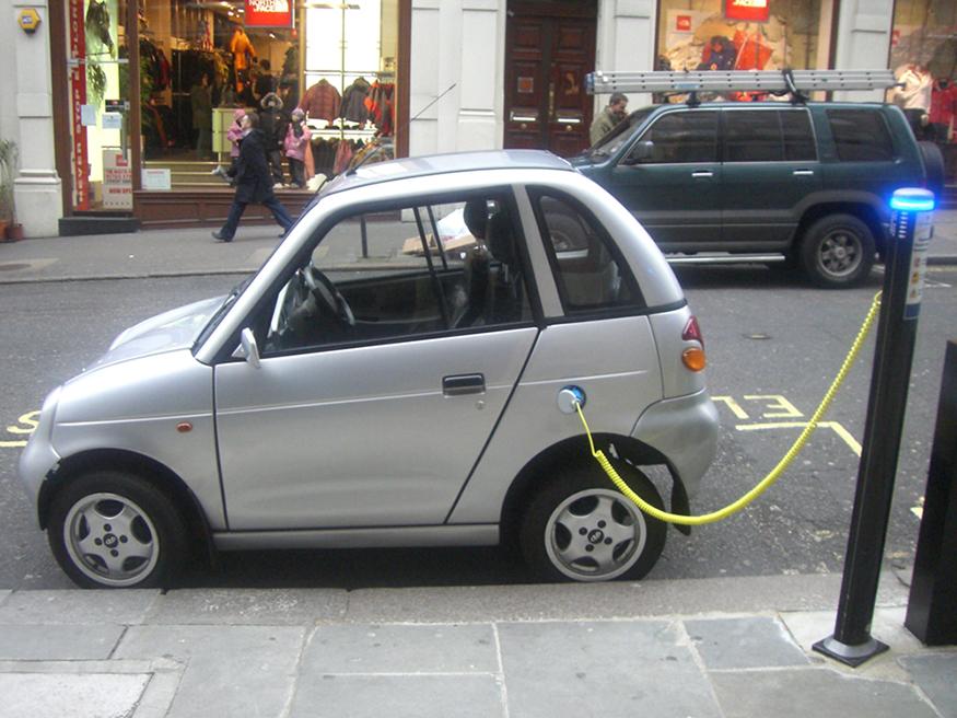 OpenStax-CNX module: m42714 13 Figure 6: This REVAi, an electric car, gets recharged on a street in London.