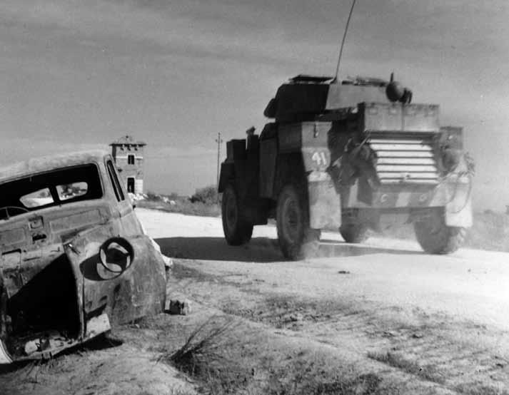 Library and Archives Canada PA 140150 A Humber Mk.IV armoured car of the 4th Princess Louise Dragoon Guards passes the wreckage of a German staff car, near Limosano, Italy, 26 October 1943.