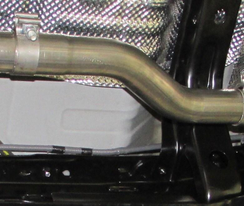 Place a clamp over the expanded end of the muffler assembly and set it up into position, insert hangers into the robber isolators. (See Fig. 6) Do Not Tighten the clamp. 4.