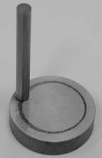 friction coefficient and wear resistance of surfaces. The tester consists of a stationary "pin" under an applied load in contact with a rotating disc.