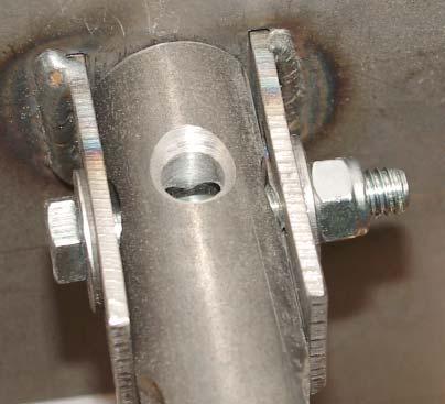 Insert a rod into a shaft-tensioning hole and pull down ¼ turn.