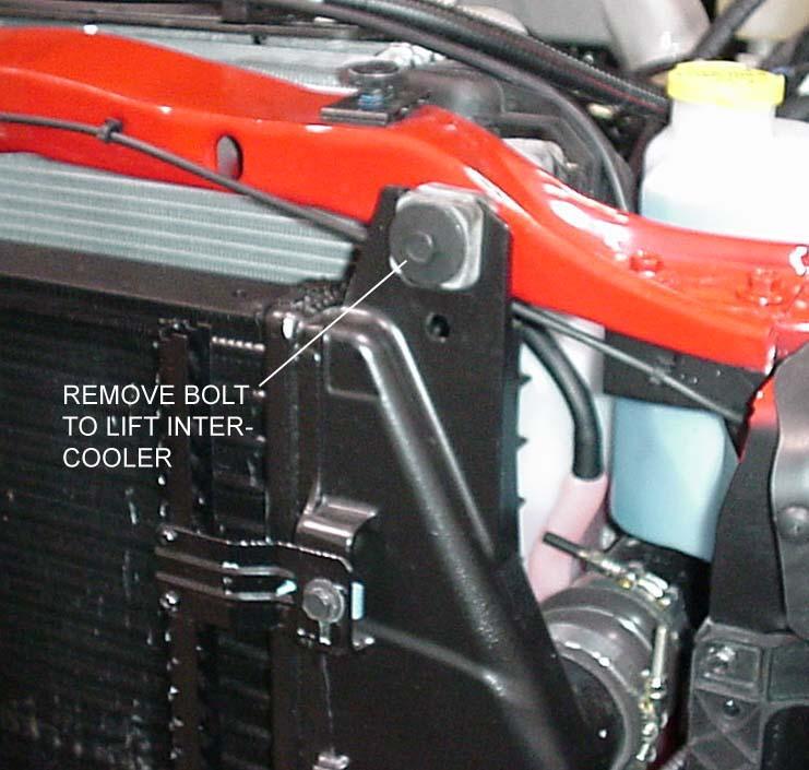 Reposition the intercooler and reinstall the upper retaining bolt. Repeat for the other side. See Figure 3 Figure 3 Intercooler retaining bolt (diesel only, left side shown) 5.