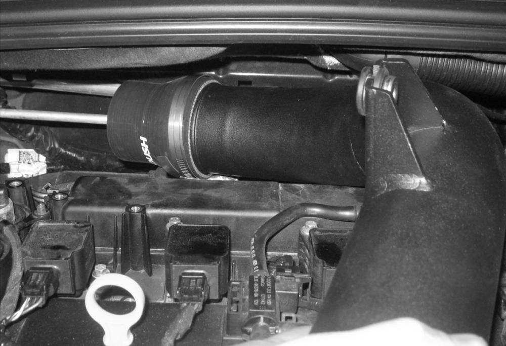 9. Place the smaller clamp (5340) over the small end of the coupler and install the