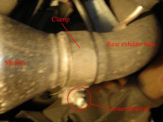 6. Similar to the above step, you need to loosen the clamp holding the muffler to the rear exhaust tube, which goes up and over the