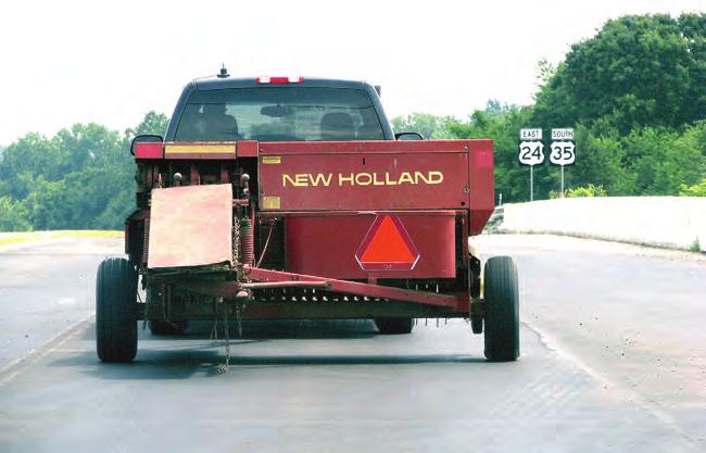 The slow moving vehicle sign does not need to be covered when the farm tractor is occasionally driven faster than 25 miles per hour on a non-interstate road