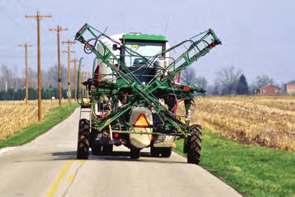 The trailer on the left, below, or the wagon to the right, could be regulated as a trailer or an implement of agriculture, depending on the highway speed at which it