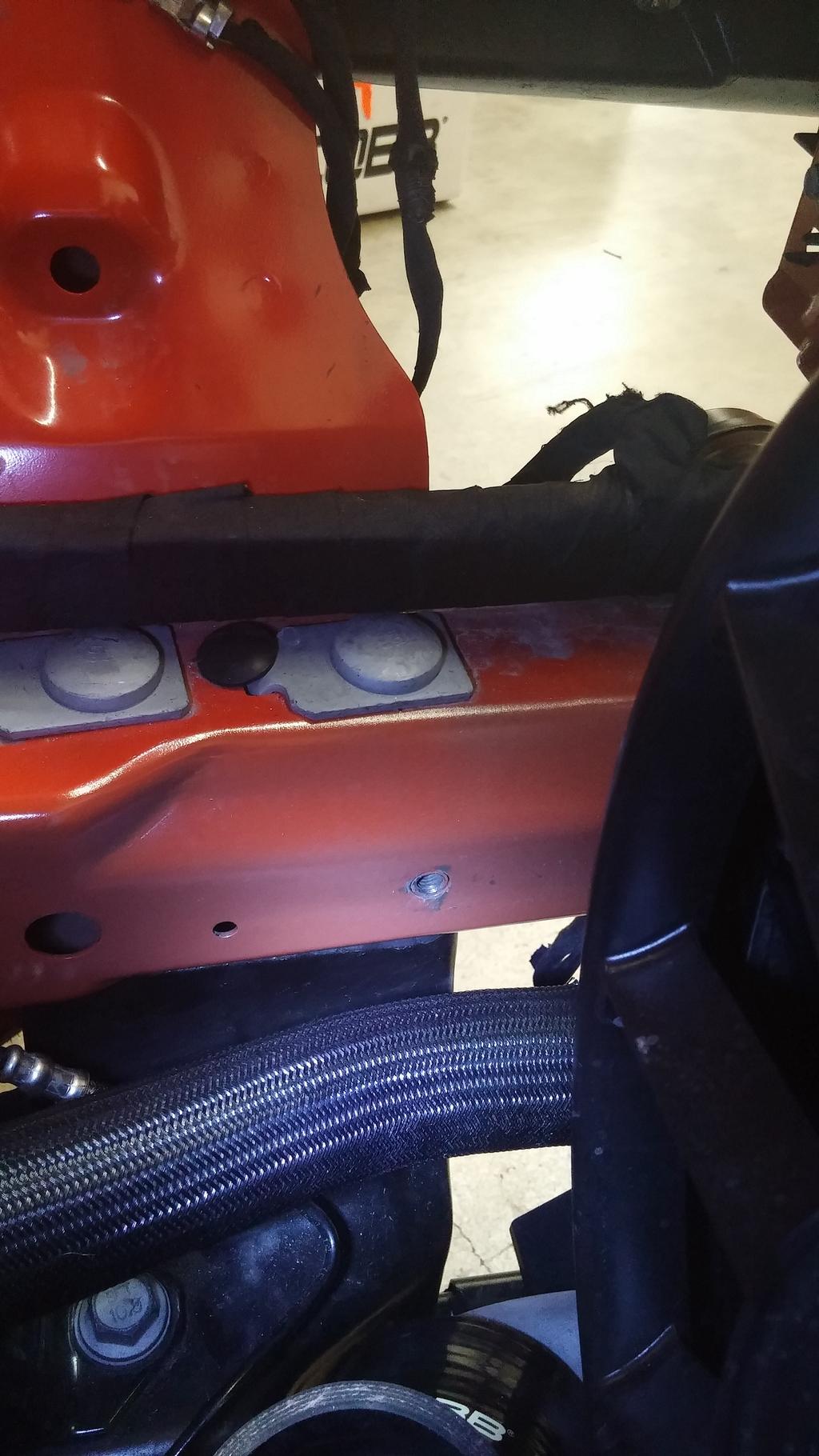 5. While the pipe is unfastened and has some wiggle room, install the lower airbox to your EB Mustang. Do this by first locating the threaded mounting hole located on the frame rail of the car.