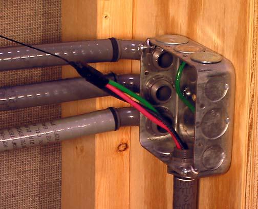 When the wires emerge into the junction box, remove the electrical tape from the wires and the fish tape eyelet.