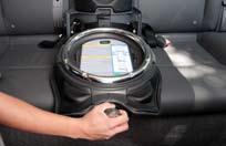 Turn the StrongArm knob at the front of the car seat base clockwise to activate the StrongArm mechanism (Photo L).