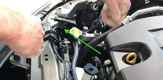 5. At the passenger side of the vehicle, route the under-hood wire