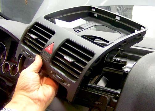 If necessary, use a flat-tipped non-marring trim removal tool to pry upward in the gap between the top of the radio and