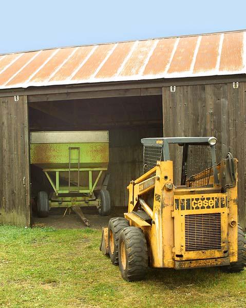skid-steer loader on his farm. He was using the loader to park gravity flow wagons in a machine shed for winter storage.