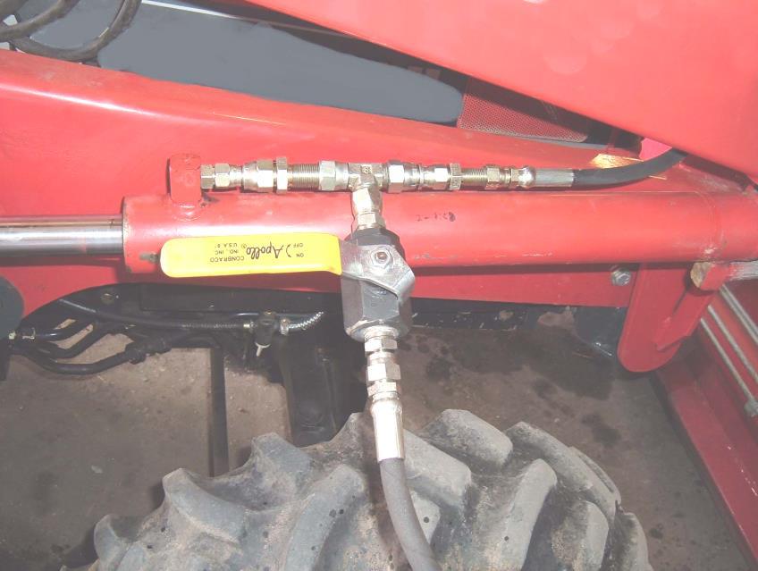 High Pressure Ball Valve and fittings installed on a loader. Lift Cylinder Rod End Hose. Tee Fitting. High Pressure Ball Valve. Drain Hose. 21.2.4.