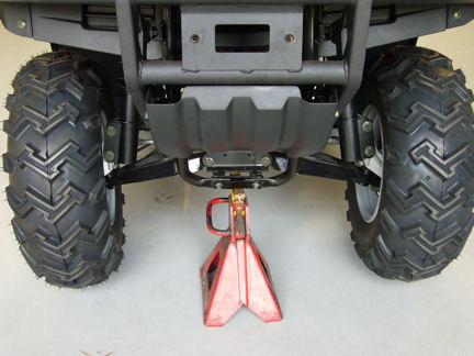 3. Lift and support the front end of the ATV with a suitable jack and jack stand that allows the vehicle to remain stable while attaching the front wheels, upper shock mounts, and bumper, if