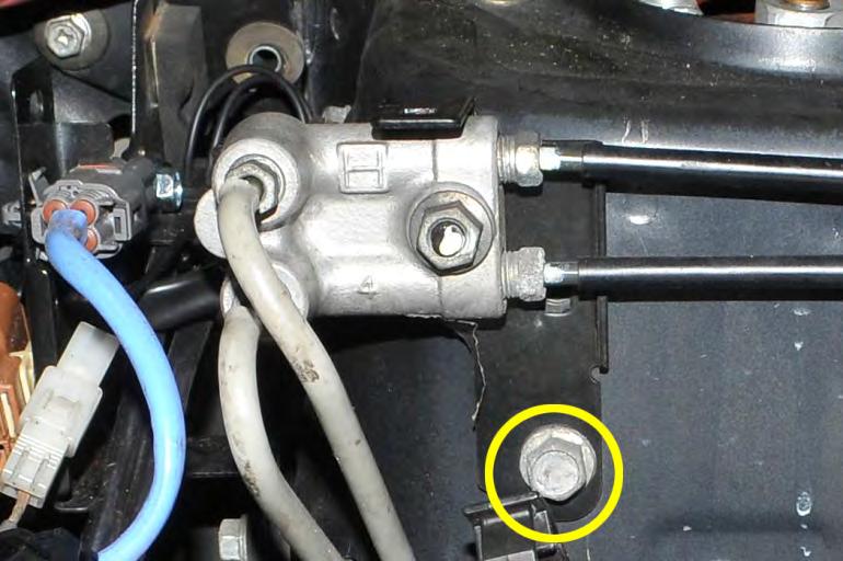 19. Remove the (1) 12mm bolt holding the brake line bracket to the strut tower.
