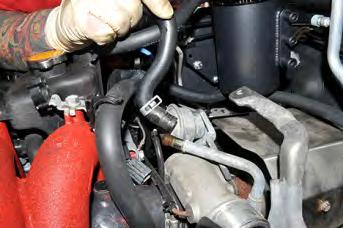 Remove the upper OEM coolant line pinch clamp and pull the OEM line off the turbocharger.