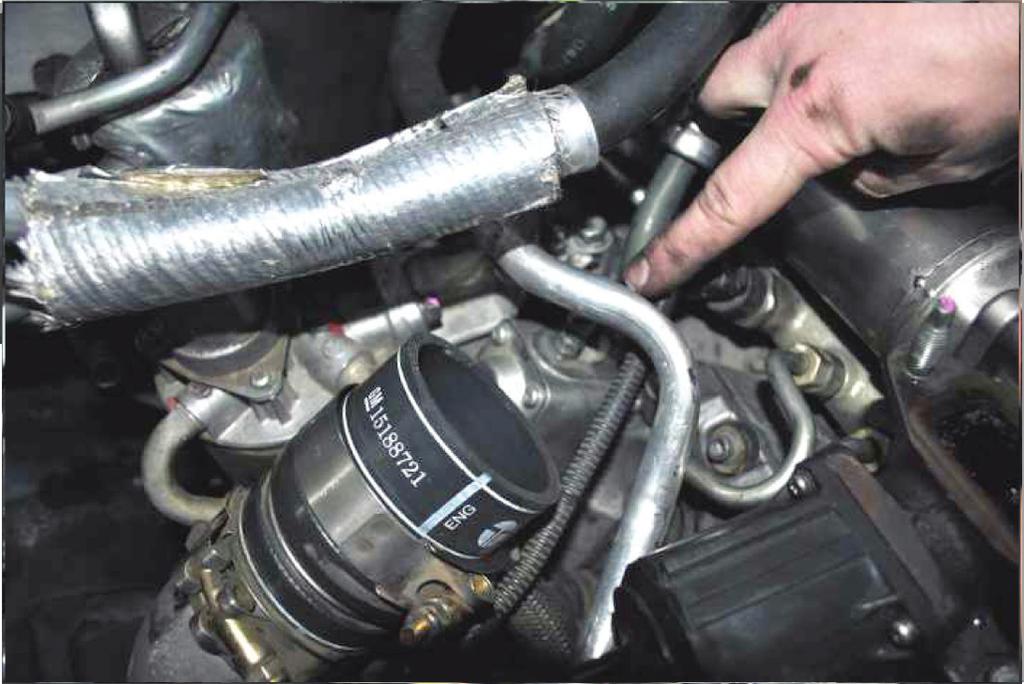 (Image 4) Note: Stuff a clean rag in the rubber boot to keep debris out of the intake system.