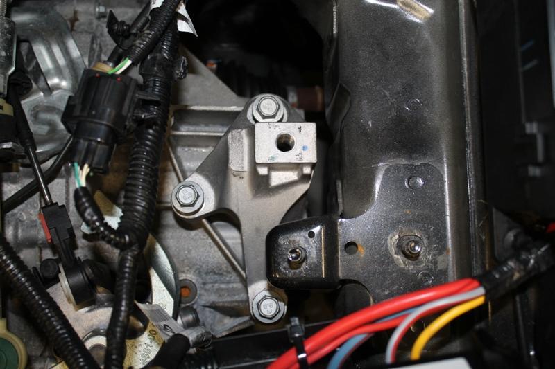 Page12 21. Using a 14mm socket, remove the 3 bolts securing the lower portion of the OEM mount to the transmission.