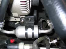 Disconnect the red positive alternator cable and the plug connector from the rear of the alternator. 2. Loosen the serpentine belt and remove it from the alternator pulley. Retain for re-installation.