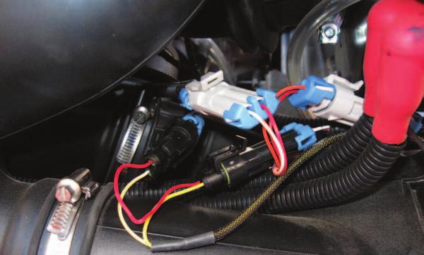 The injector harness connectors are located next to the ignition coils.