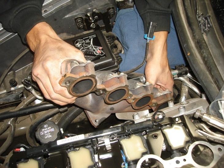 Loosen and remove the passenger-side factory exhaust manifold bolts. Place hardware to the side for use during reinstallation.
